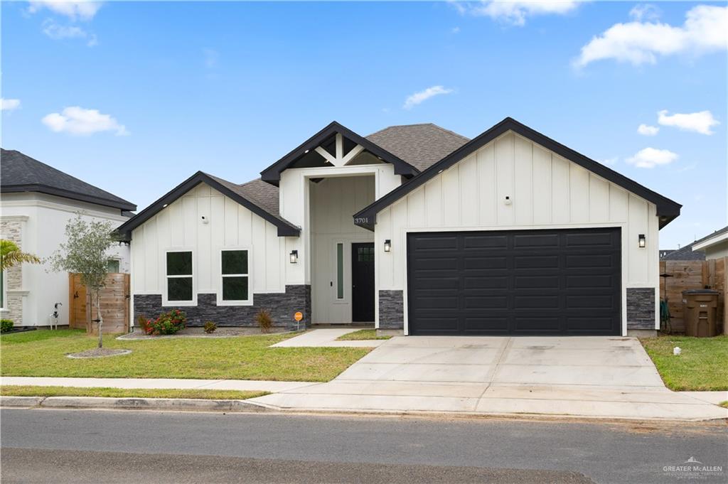3701 South Solstice Road Edinburg, TX 78542 - Photo 2 of 17 a front view of a house with a yard and garage