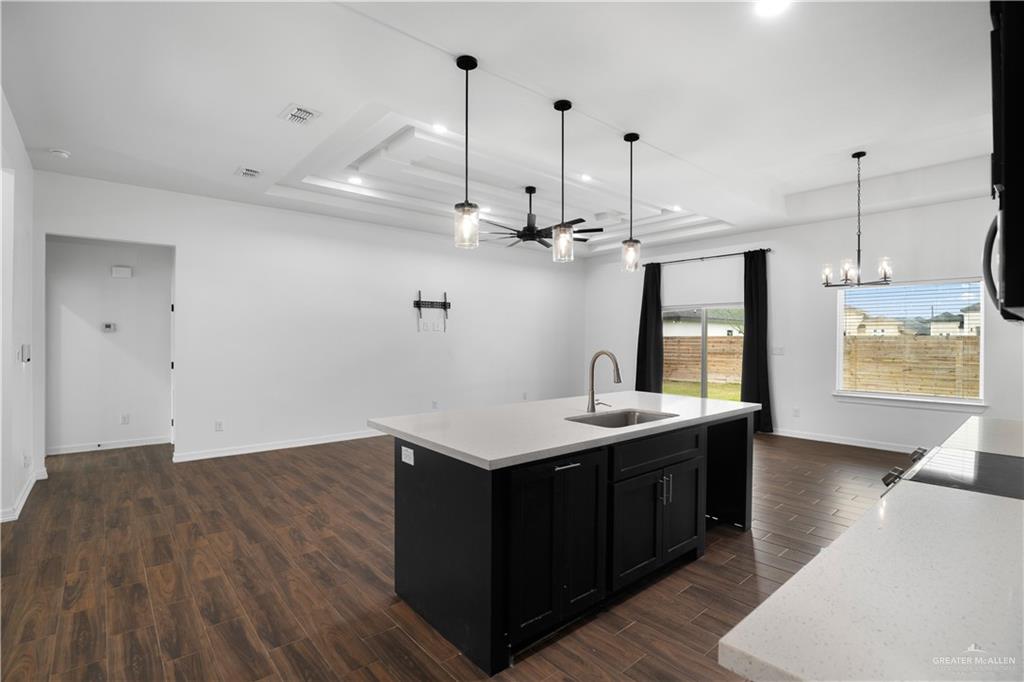 3701 South Solstice Road Edinburg, TX 78542 - Photo 6 of 17 a kitchen with a sink a window and wooden floor