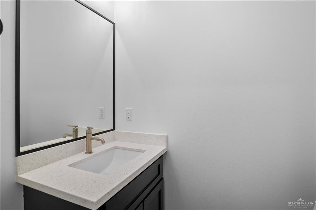 3701 South Solstice Road Edinburg, TX 78542 - Photo 8 of 17 a bathroom with a sink and a mirror