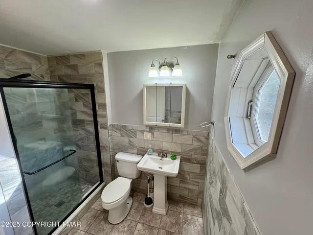 a view of a kitchen with a stove wooden cabinets and utility