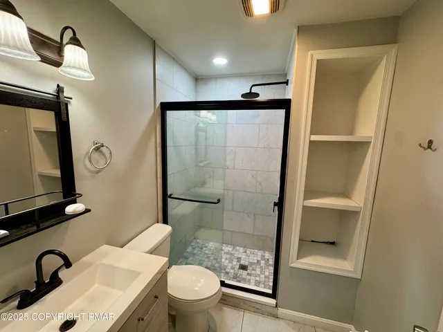 a bathroom with a sink a toilet and a mirror