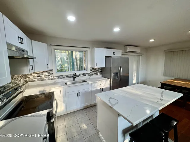 a kitchen with a sink a stove a refrigerator and cabinets
