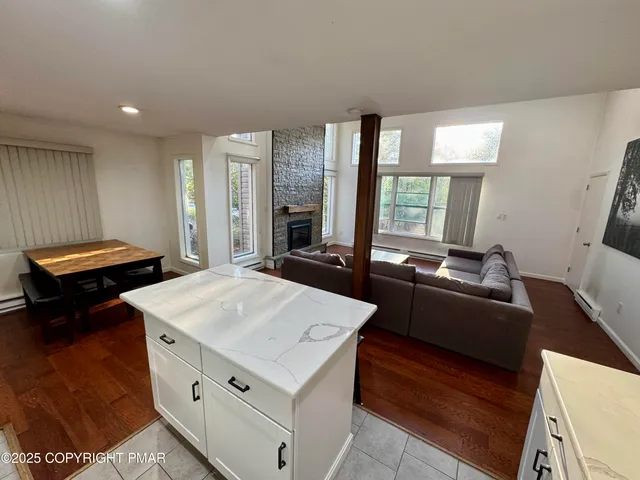 a living room with a table and a large window