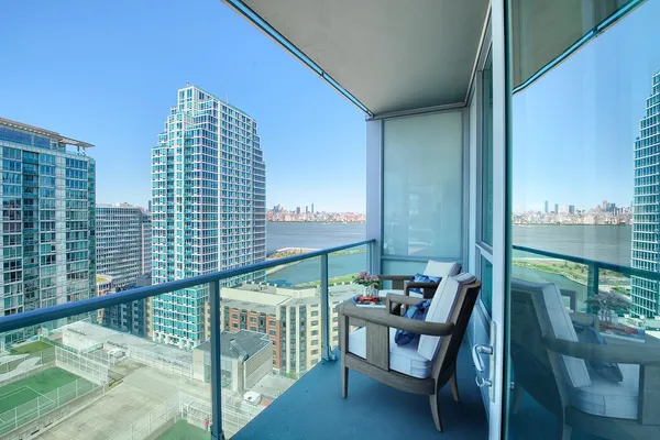 a balcony with furniture and a potted plant