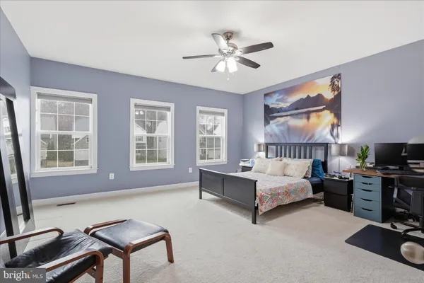 a view of walk in closet with clothes