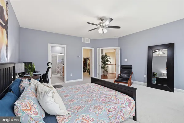 a bathroom with a granite countertop sink a toilet and a mirror