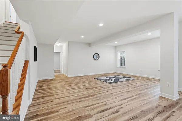 a bathroom with a sink a toilet a mirror and shower