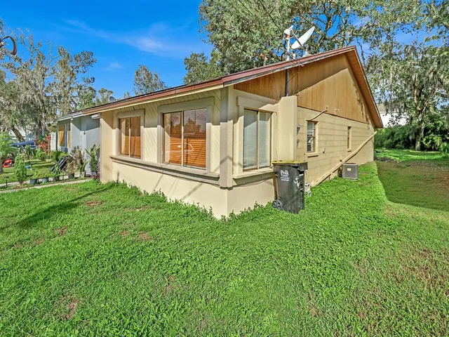 a backyard of a house with wooden floor and fence