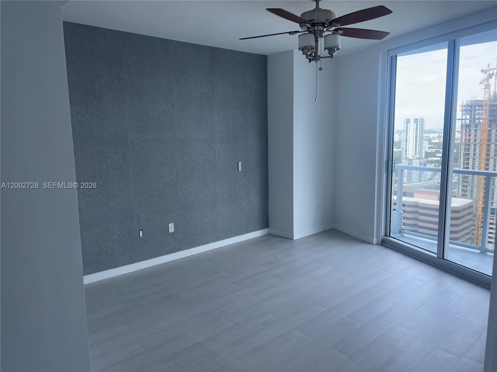 185 Southwest 7th Street, Unit 2705 Miami, FL 33130 - Photo 5 of 5 an empty room with windows and entrance