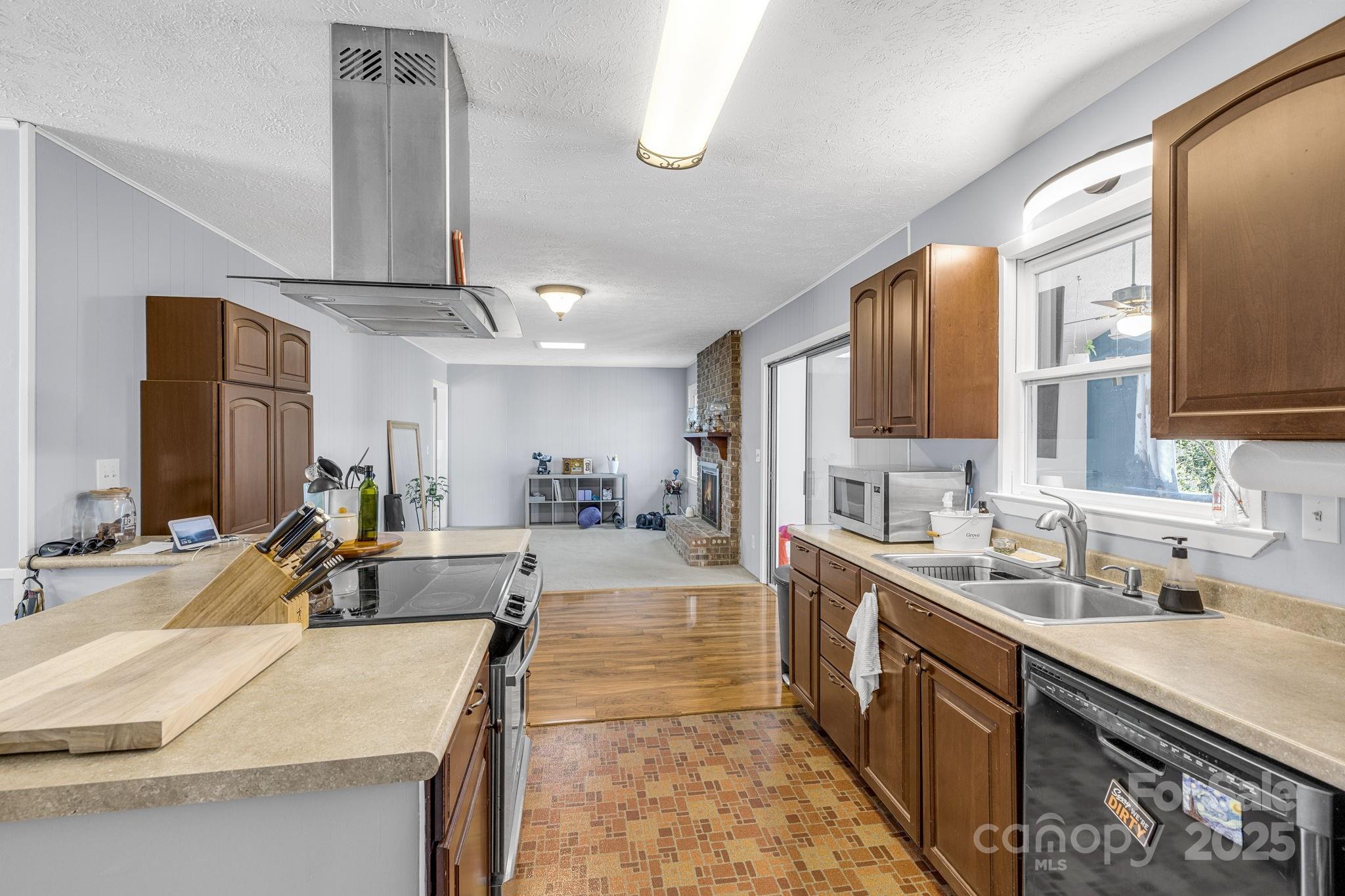 110 Cannon Drive Hendersonville, NC 28792 - Photo 11 of 36 a large kitchen with kitchen island a large counter top space a sink stainless steel appliances and cabinets