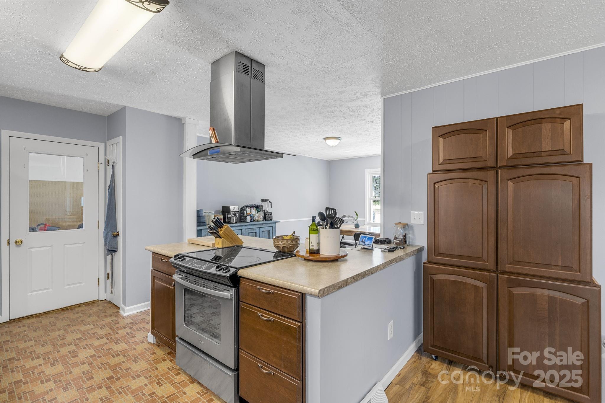 110 Cannon Drive Hendersonville, NC 28792 - Photo 13 of 36 a kitchen with stainless steel appliances granite countertop a sink stove and refrigerator