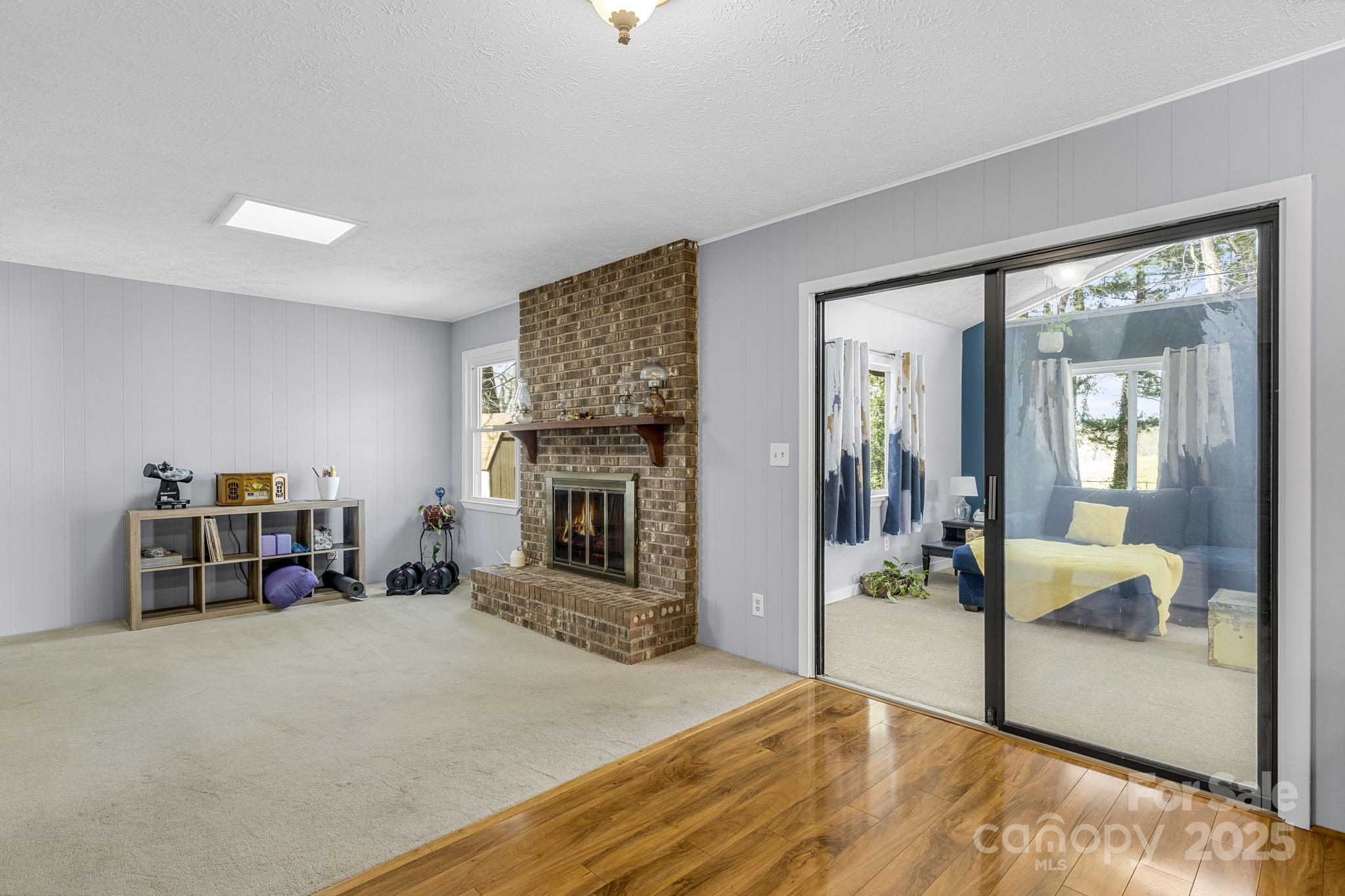 110 Cannon Drive Hendersonville, NC 28792 - Photo 14 of 36 a bedroom with furniture and a fireplace