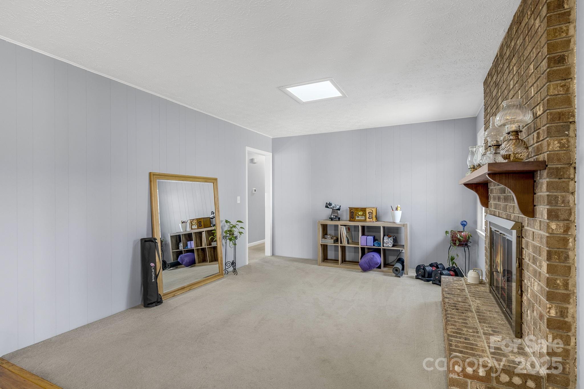 110 Cannon Drive Hendersonville, NC 28792 - Photo 15 of 36 a view of a livingroom with furniture and a fireplace