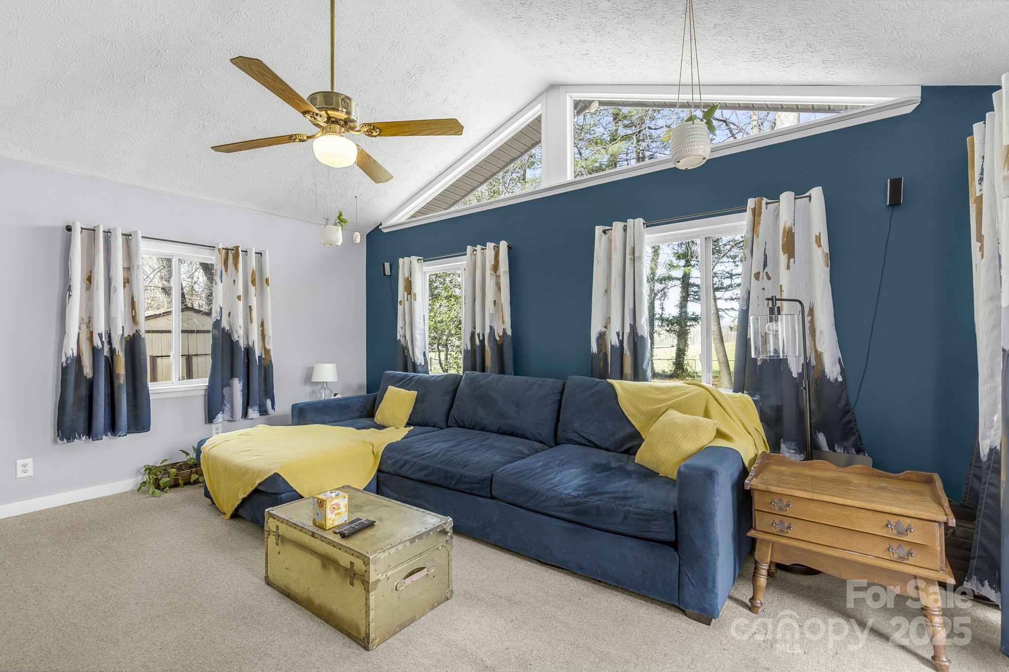 110 Cannon Drive Hendersonville, NC 28792 - Photo 18 of 36 a living room with furniture a chandelier and a chandelier