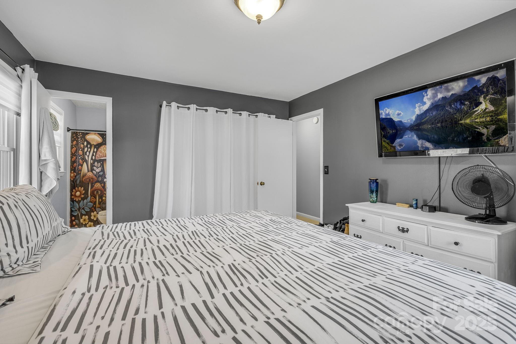 110 Cannon Drive Hendersonville, NC 28792 - Photo 21 of 36 a bedroom with a bed and a flat screen tv