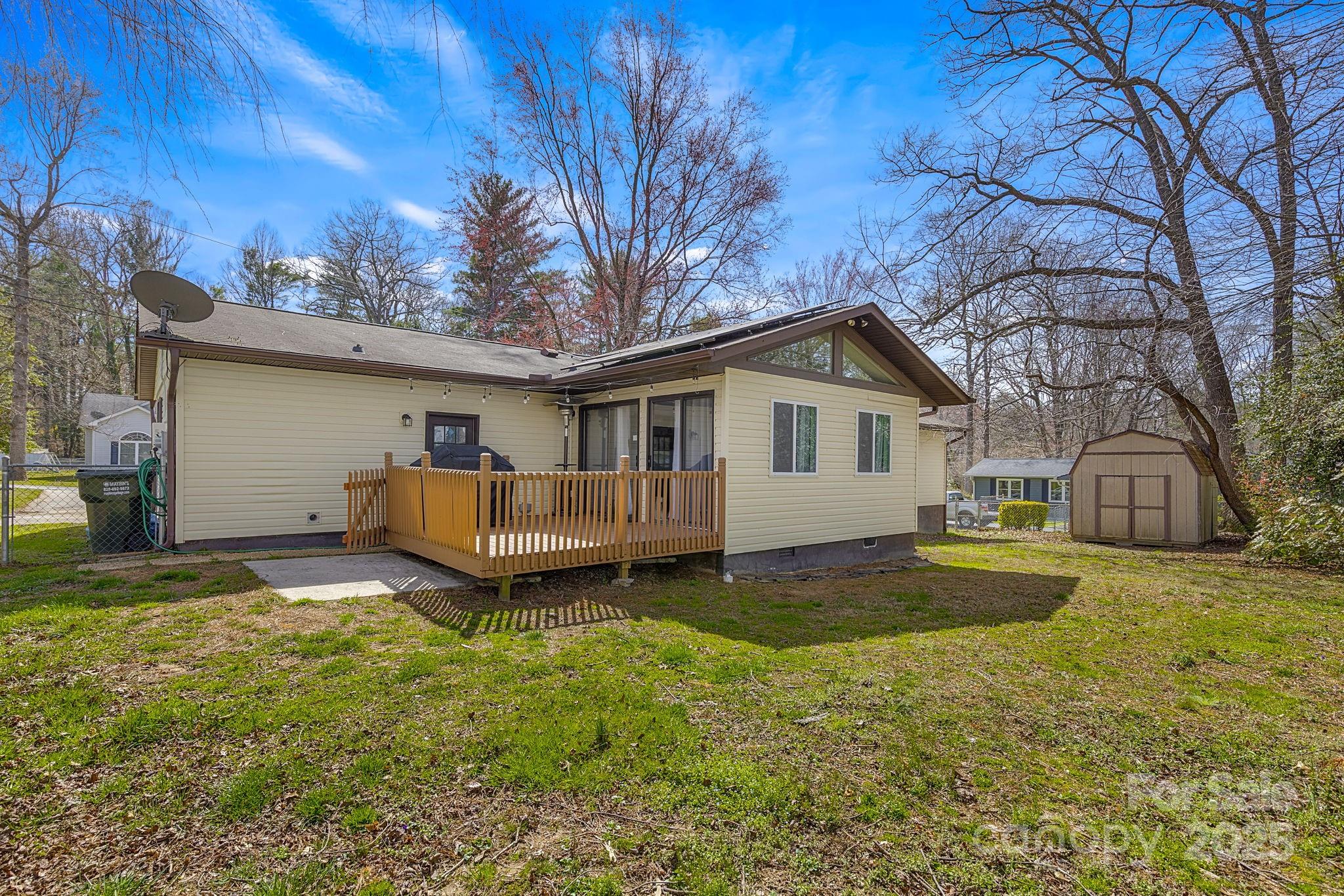 110 Cannon Drive Hendersonville, NC 28792 - Photo 28 of 36 a view of a house with pool and trees in the background