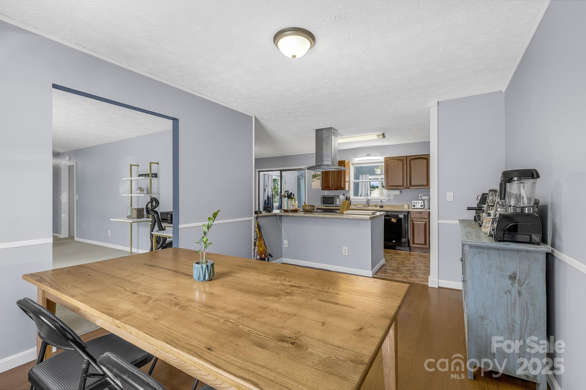 110 Cannon Drive Hendersonville, NC 28792 - Photo 9 of 36 a kitchen with a table and chairs in it