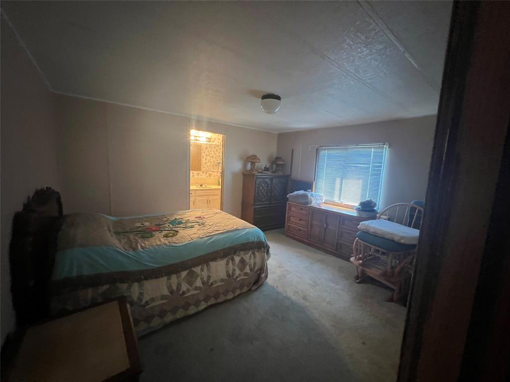 0 Holland Road Forestburg, TX 76239 - Photo 27 of 38 a bedroom with bed and window