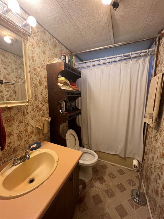 0 Holland Road Forestburg, TX 76239 - Photo 29 of 38 a bathroom with a sink toilet and shower
