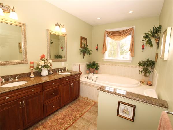 64 Osgood Road Sterling, MA 01564 - Photo 16 of 30 a bathroom with a granite countertop sink a large mirror a bathtub and a shower