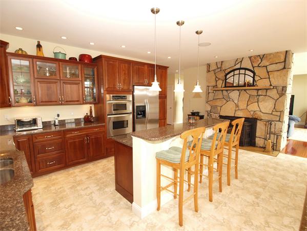 64 Osgood Road Sterling, MA 01564 - Photo 3 of 30 a kitchen with stainless steel appliances kitchen island granite countertop a table and chairs in it