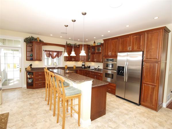 64 Osgood Road Sterling, MA 01564 - Photo 4 of 30 a kitchen with stainless steel appliances granite countertop a refrigerator a stove and a sink with cabinets
