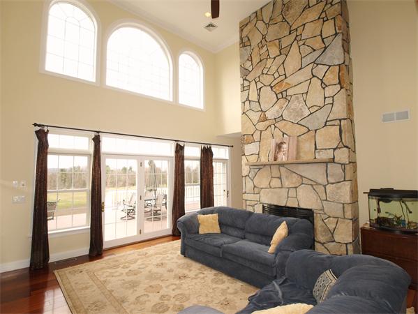 64 Osgood Road Sterling, MA 01564 - Photo 8 of 30 a living room with furniture and a floor to ceiling window
