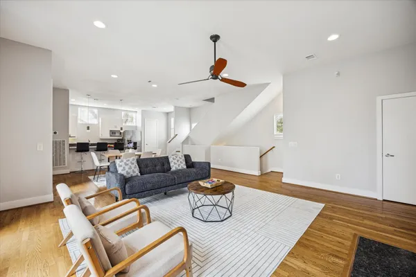 a living room with furniture and wooden floor