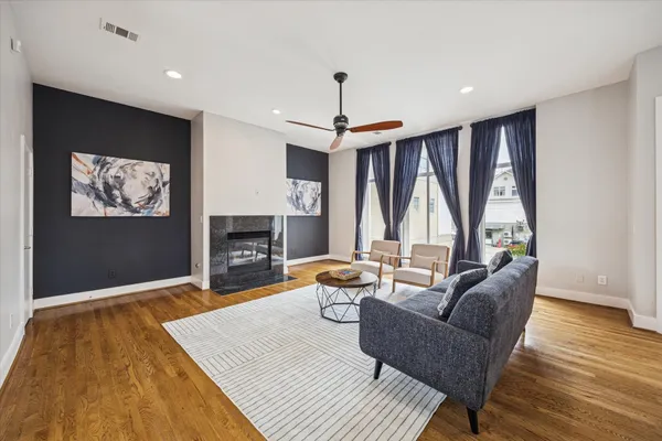 a living room with furniture a fireplace and a flat screen tv