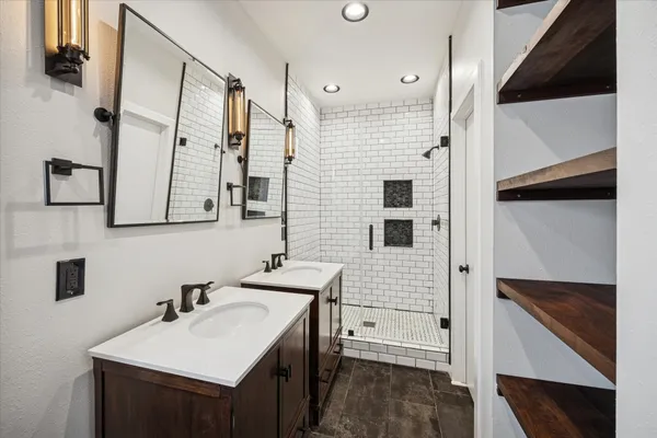 a bathroom with a sink a mirror and a shower