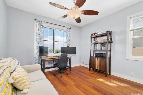 a view of a workspace with furniture and a window