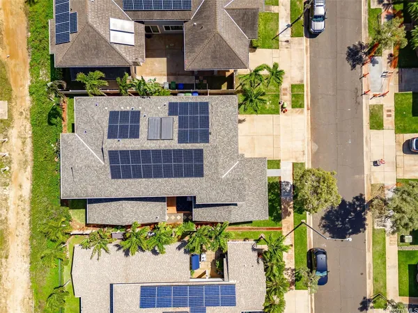 a aerial view of a house with a yard and potted plants