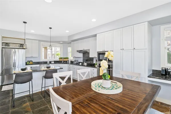 a kitchen with a dining table and chairs