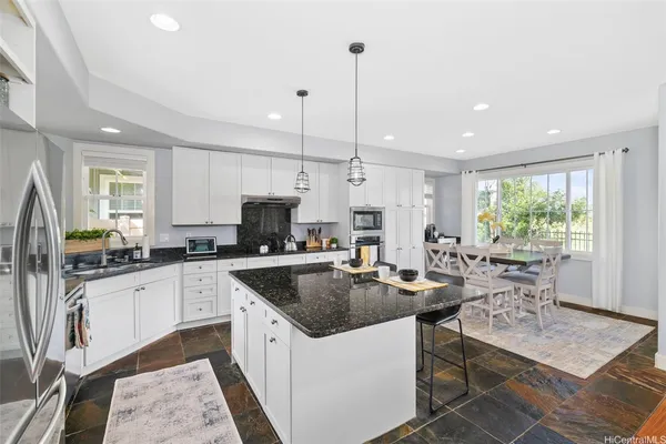 a kitchen with counter space appliances and a window