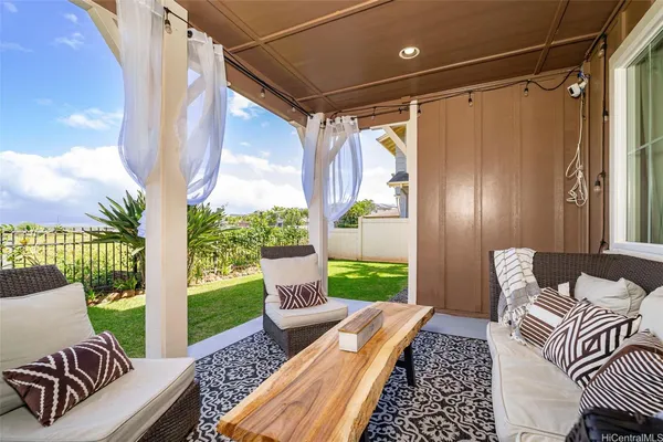 a balcony with furniture and a potted plant