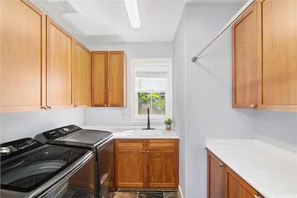 a kitchen with granite countertop a sink a stove and cabinets