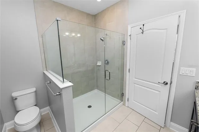 a bathroom with a granite countertop sink a toilet and a mirror