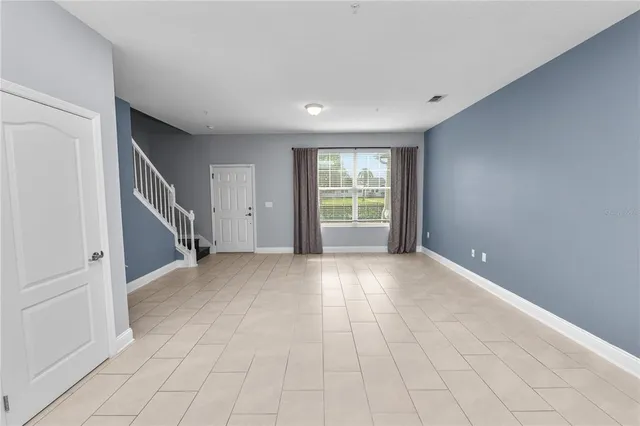 a large kitchen with a large counter top a sink and stainless steel appliances