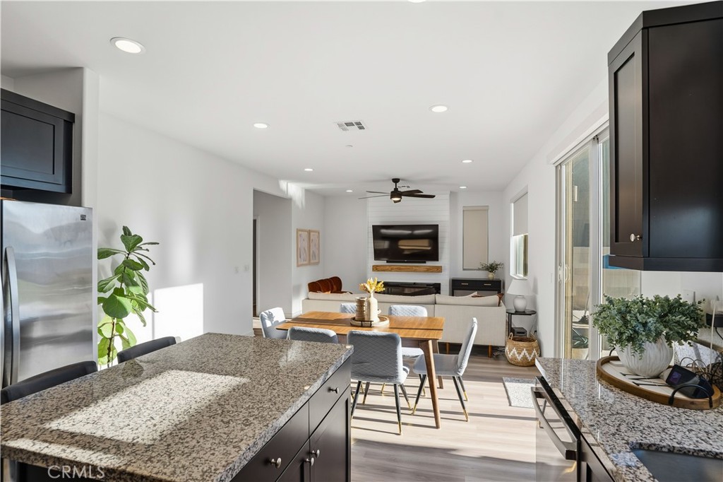 11479 Sheridan Way Beaumont, CA 92223 - Photo 11 of 40 a living room with stainless steel appliances kitchen island granite countertop furniture and a kitchen view