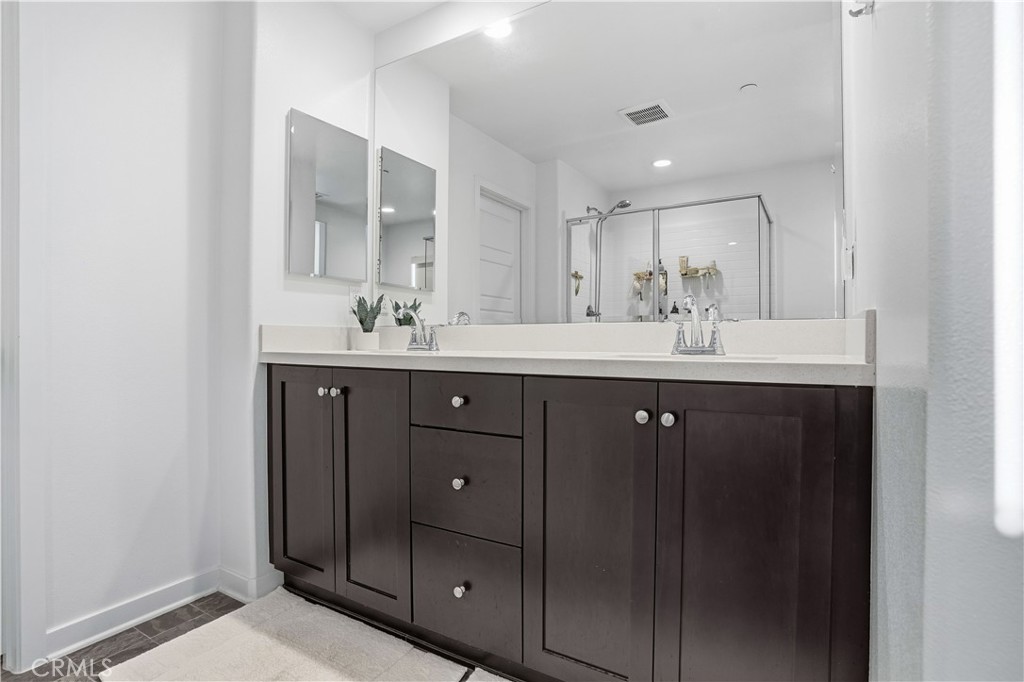 11479 Sheridan Way Beaumont, CA 92223 - Photo 15 of 40 a bathroom with a double vanity sink and mirror