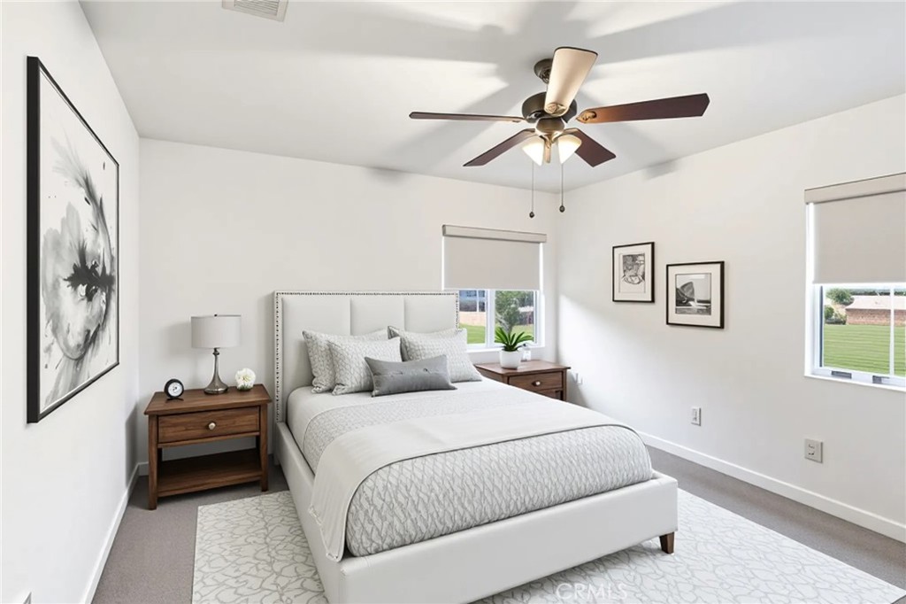 11479 Sheridan Way Beaumont, CA 92223 - Photo 17 of 40 a bedroom with a bed and a chandelier