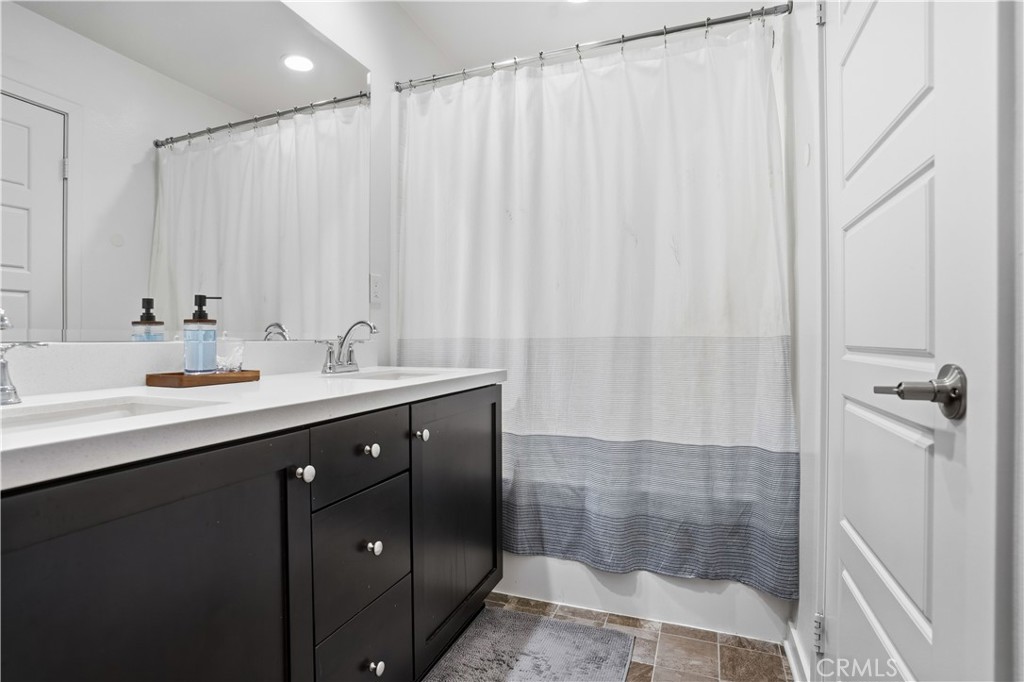 11479 Sheridan Way Beaumont, CA 92223 - Photo 18 of 40 a bathroom with a double vanity sink and mirror