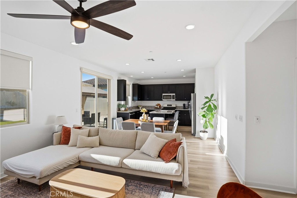 11479 Sheridan Way Beaumont, CA 92223 - Photo 7 of 40 a living room with furniture kitchen view and a window