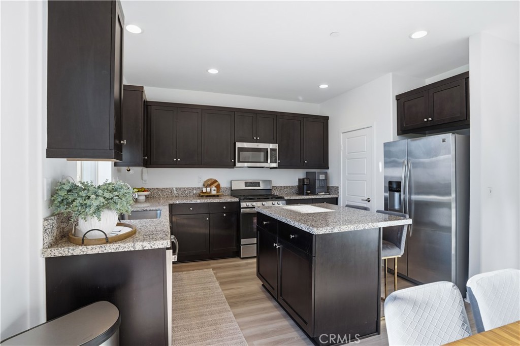 11479 Sheridan Way Beaumont, CA 92223 - Photo 10 of 40 a kitchen with a refrigerator a stove top oven a sink and cabinets