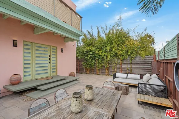 a backyard of a house with barbeque oven table and chairs
