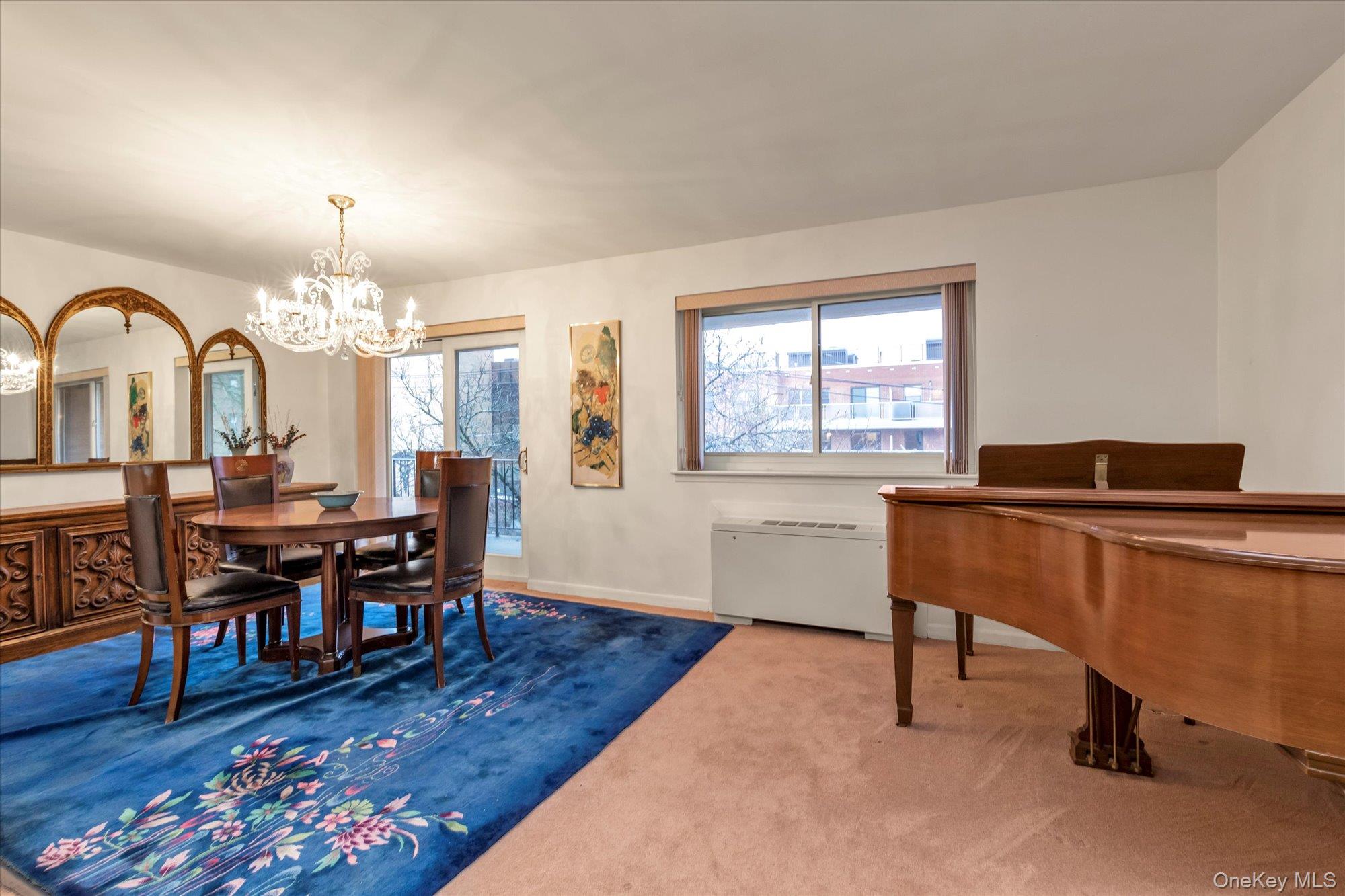 30 Barstow Road, Unit 3A Great Neck, NY 11021 - Photo 5 of 17 a view of a livingroom with furniture and a chandelier