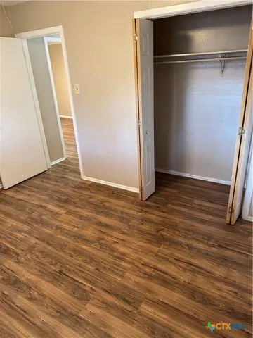 an empty room with wooden floor