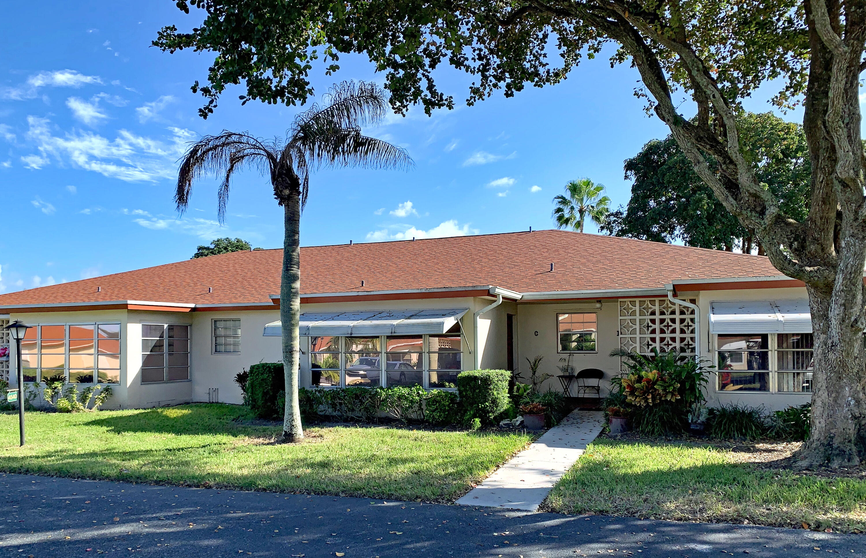 4540 Northwest 3rd Court, Unit C Delray Beach, FL 33445 - Photo 1 of 29 a front view of a house with garden
