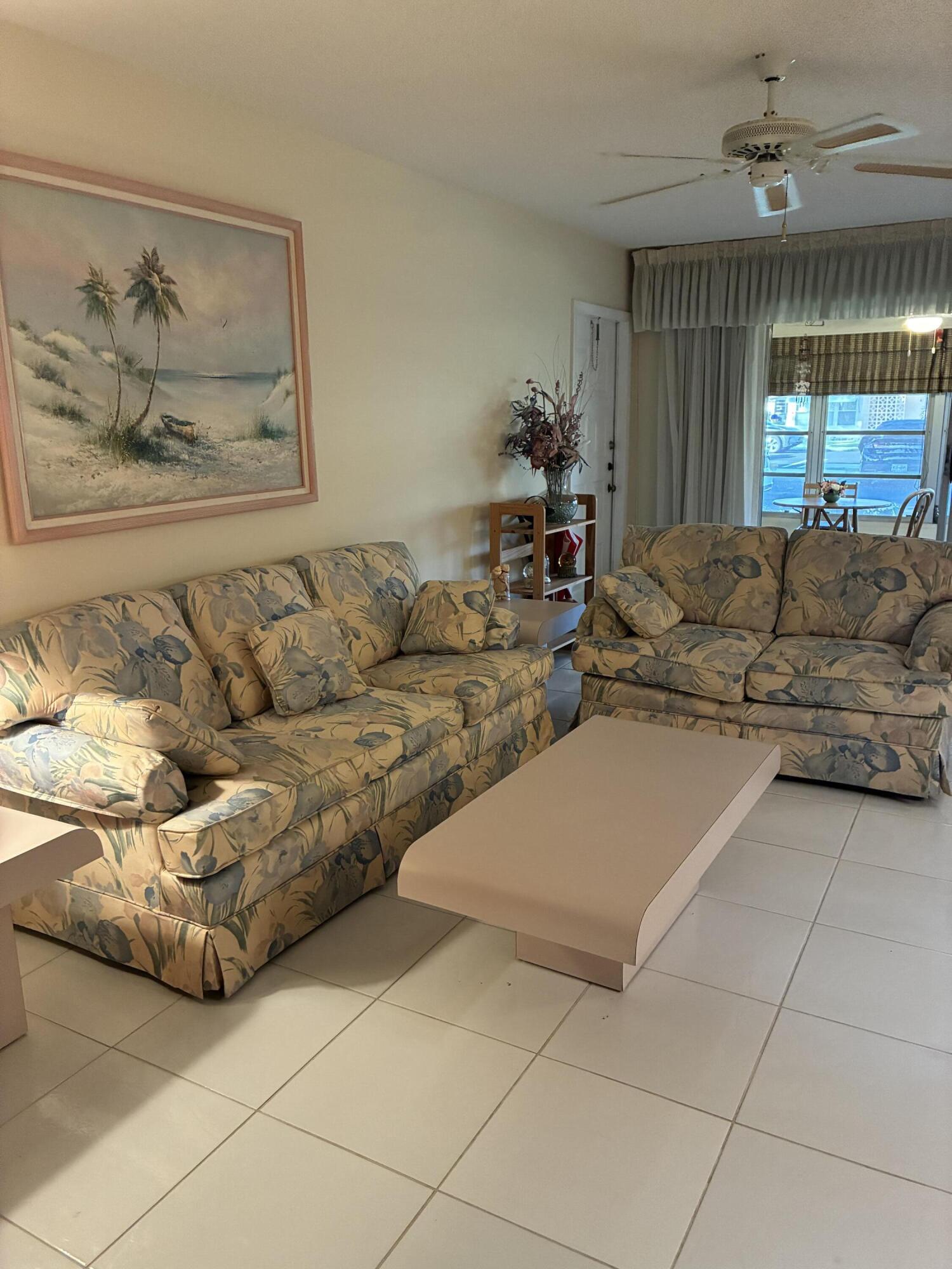 4540 Northwest 3rd Court, Unit C Delray Beach, FL 33445 - Photo 14 of 29 a living room with furniture and a chandelier