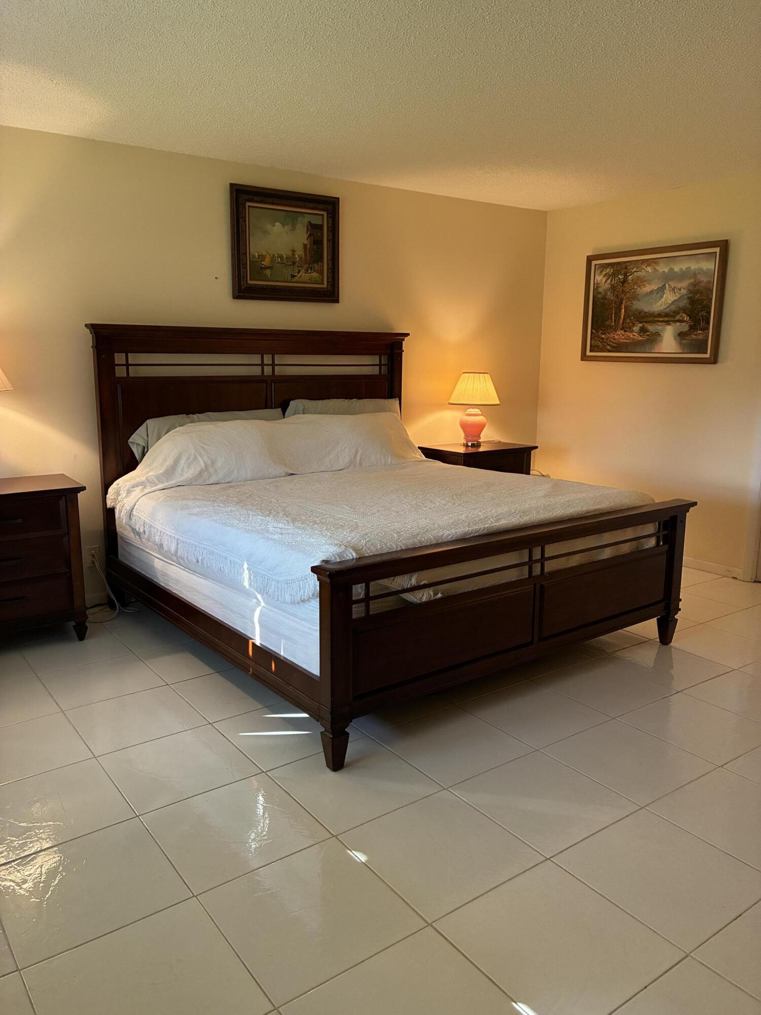 4540 Northwest 3rd Court, Unit C Delray Beach, FL 33445 - Photo 18 of 29 a bedroom with a bed and window